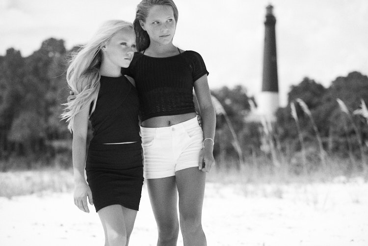 two girls posing in front of Pensacola lighthouse